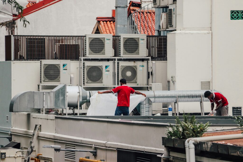 Employees working on a commercial cooling system